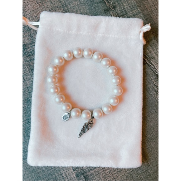 Juicy Couture Jewelry - Juicy Couture faux pearl bracelet with wing charm